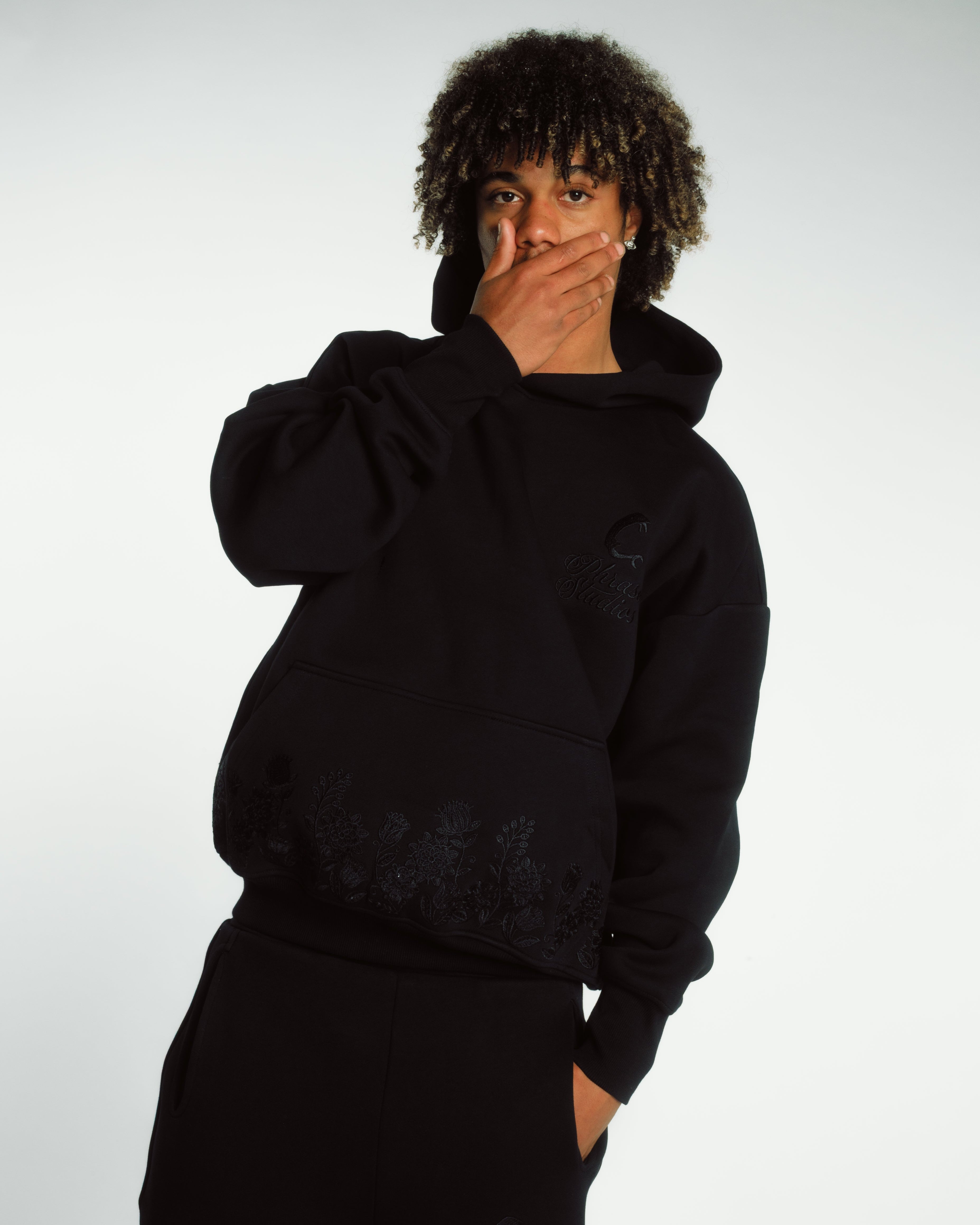 Unisex black hoodie with embroidered floral design