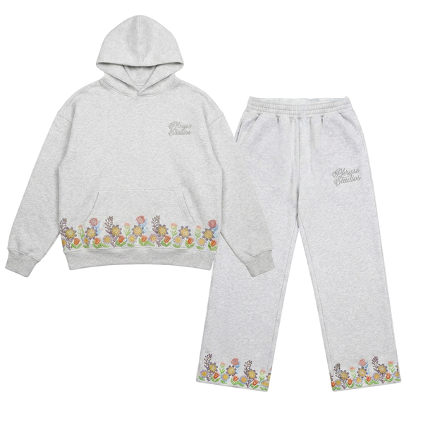 Floral Bloom embroidered flower tracksuit, hoodie and joggers laid flat in sage cotton.
