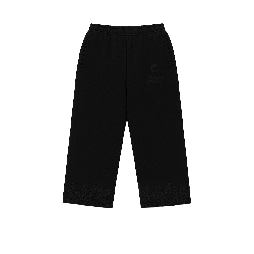 Black floral track pants with embroidered details