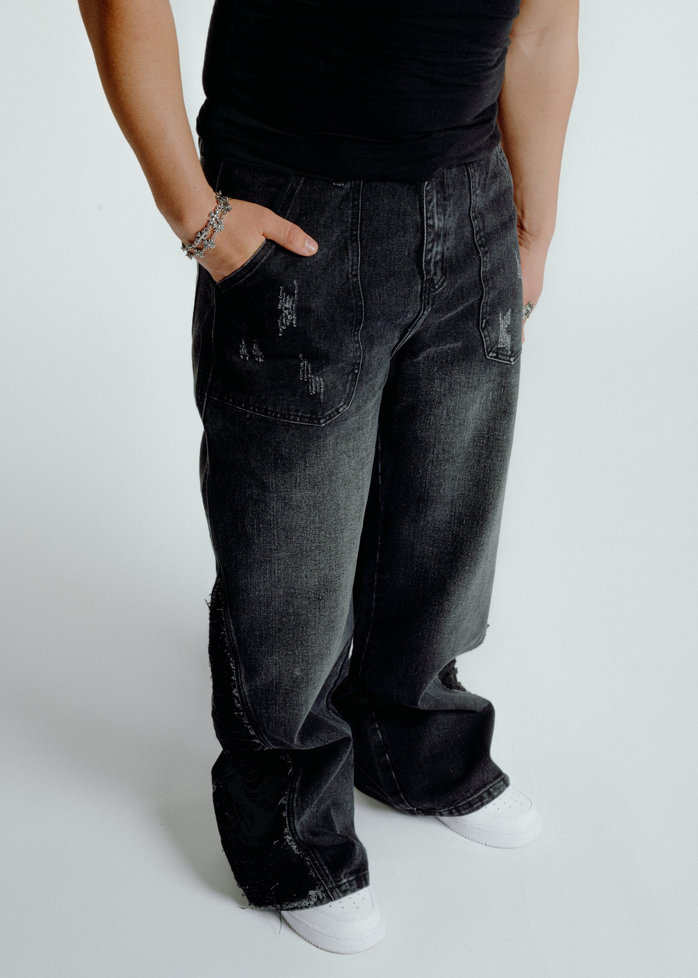 Model wearing Resurge Jeans - Distressed Resilient 100% Cotton Flare with wide leg fit and front patch pockets, styled with white sneakers.