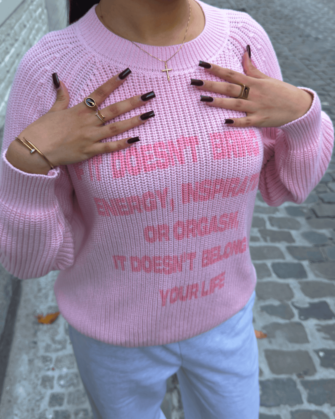 Women wearing pink Manifest Knit sweater with jewelry