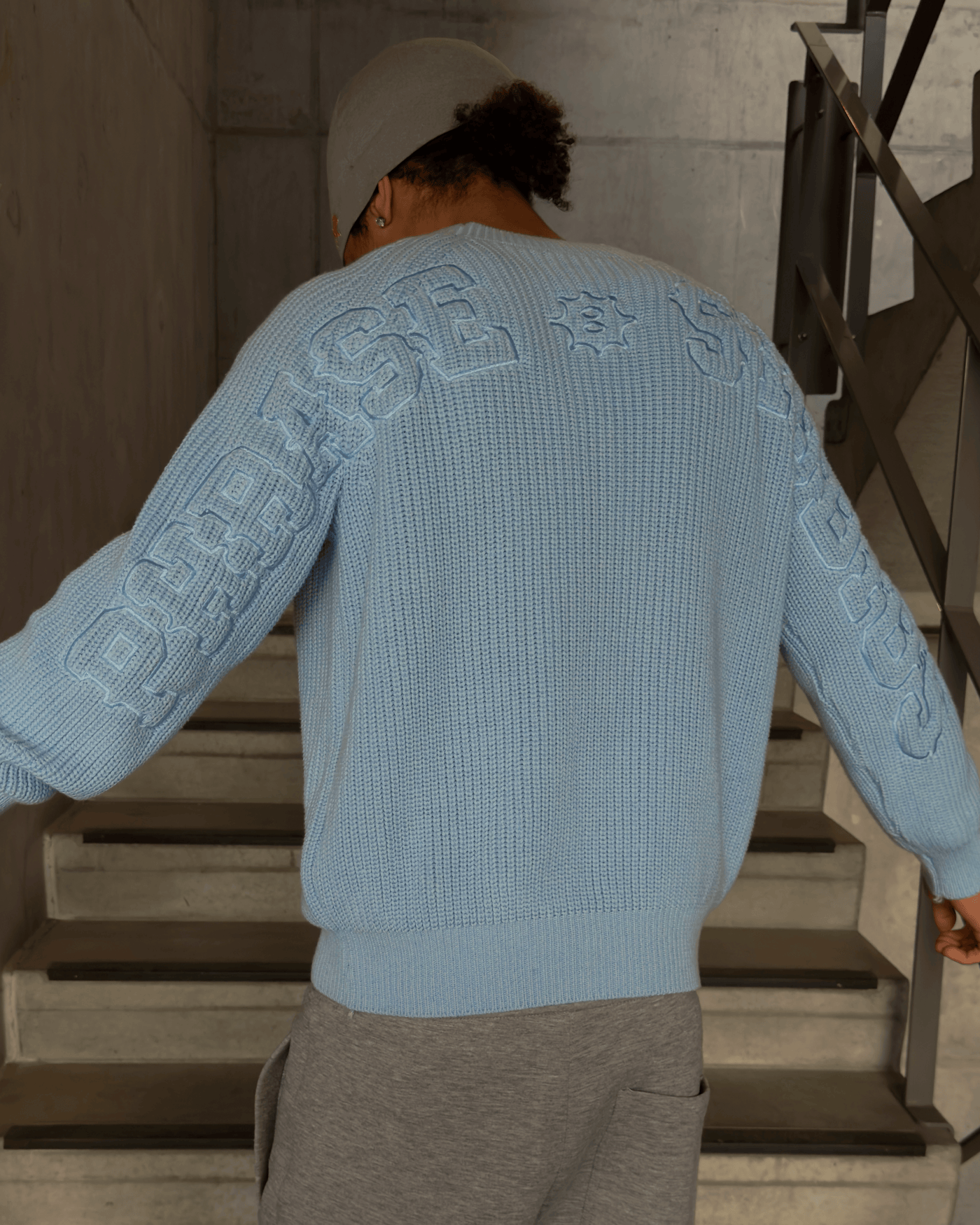 Model wearing Blue Horizon Knit sweater outdoors
