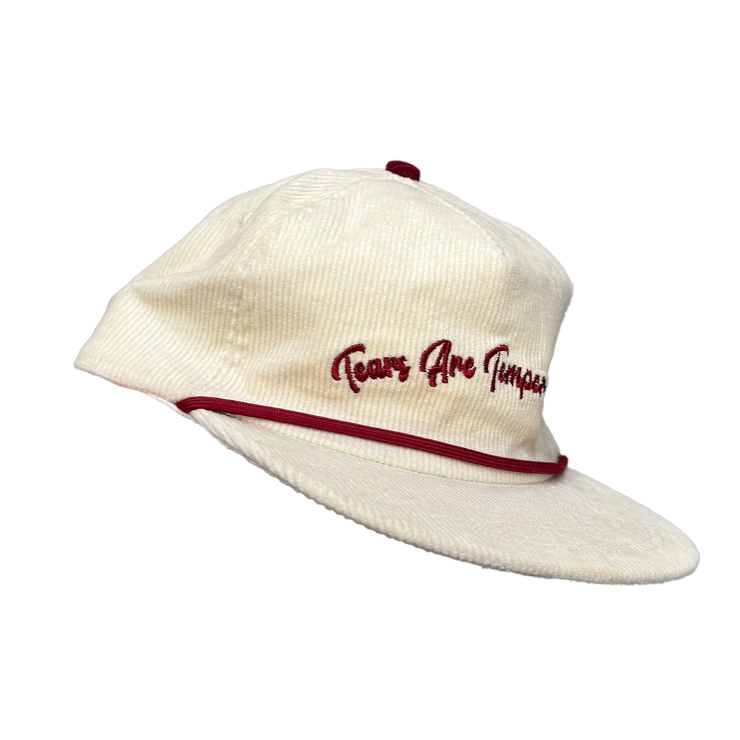 Side view of cream corduroy hat with adjustable strap